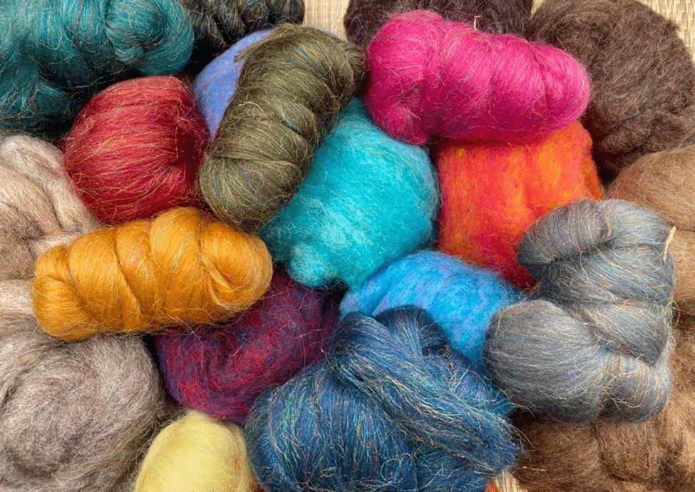 A variety of carded wool and roving for needle felting Enter the Wildwoods
