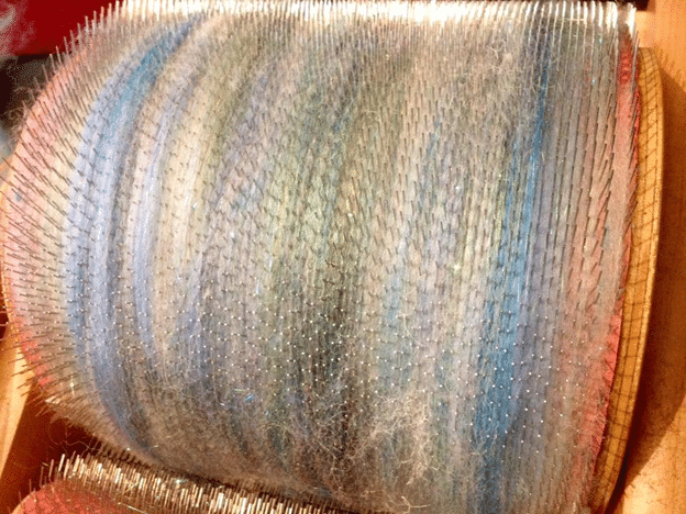 Fibres being mixed on a drum carder